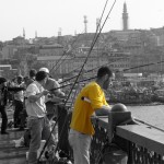 Galata Bridge Istanbul Turkey Fisherman in Yellow Tee shirt