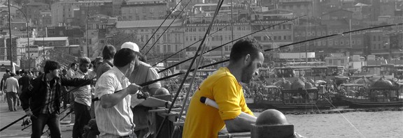 Galata Bridge Istanbul Turkey Fisherman in Yellow Tee shirt